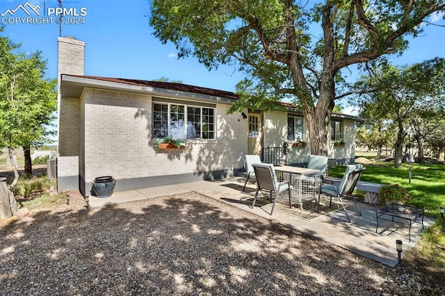 back of property with a patio area and cooling unit