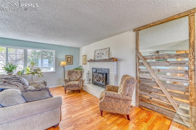 living room with wood-type flooring and a textured ceiling