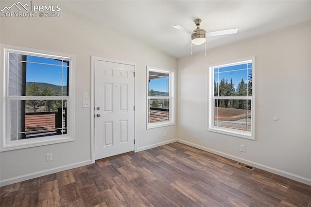 entryway with dark hardwood / wood-style floors, ceiling fan, and vaulted ceiling