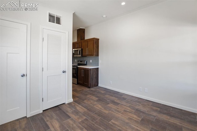 kitchen with dark brown cabinetry, dark hardwood / wood-style flooring, tasteful backsplash, and stainless steel appliances