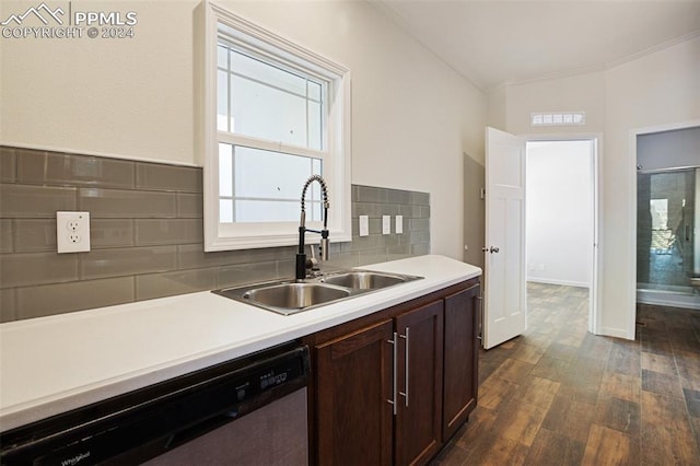 kitchen featuring dark hardwood / wood-style floors, backsplash, sink, stainless steel dishwasher, and dark brown cabinetry