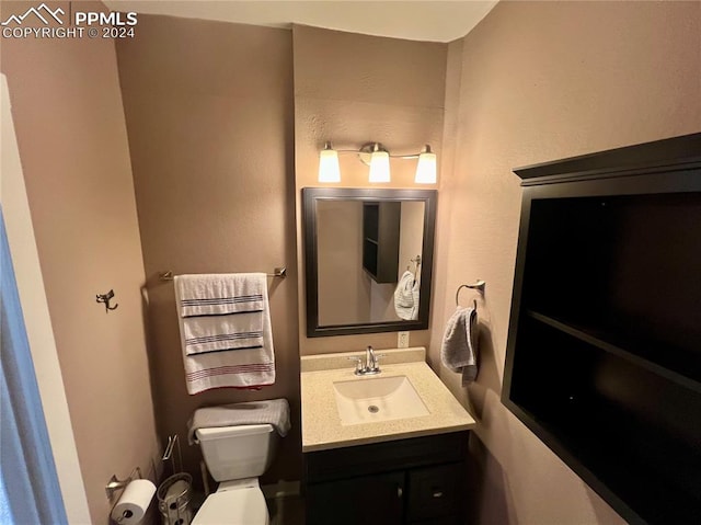 bathroom featuring toilet and vanity