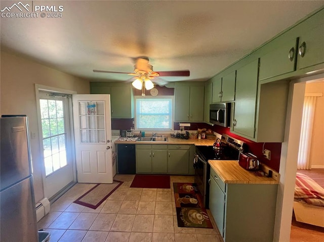 kitchen with a healthy amount of sunlight, stainless steel appliances, ceiling fan, and green cabinetry