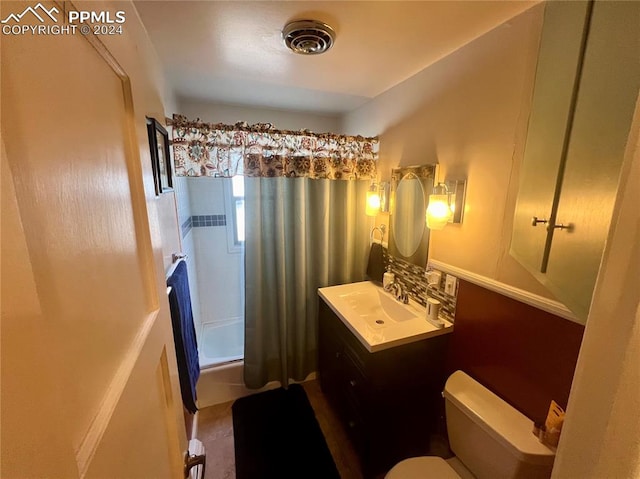 bathroom with tile flooring, oversized vanity, and toilet