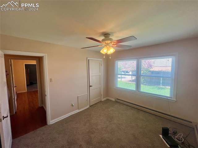 unfurnished bedroom with a baseboard radiator, ceiling fan, and carpet