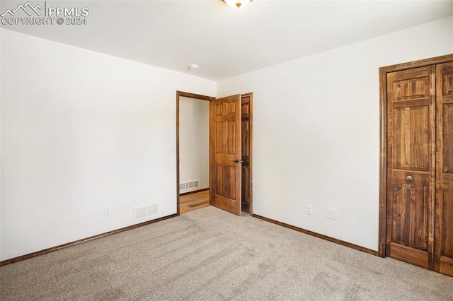 unfurnished bedroom with light carpet