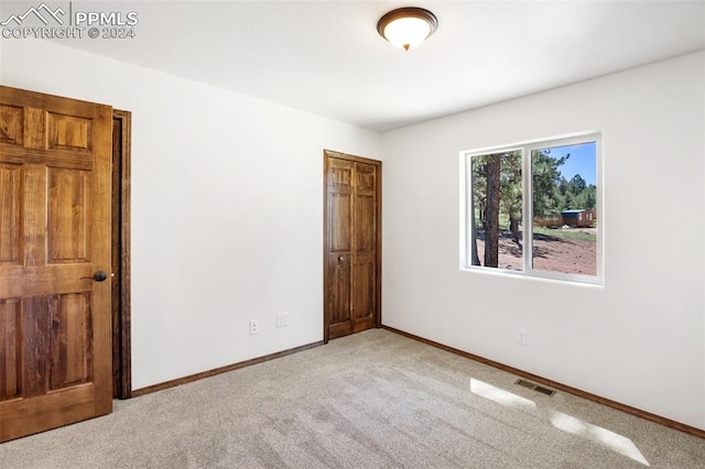 unfurnished bedroom with light carpet