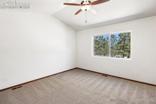 empty room with ceiling fan, carpet, and lofted ceiling