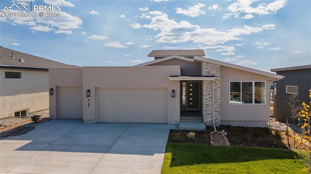 view of front facade with a garage and a front lawn