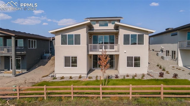 rear view of property featuring a balcony