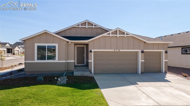 view of front of house with a front yard and a garage