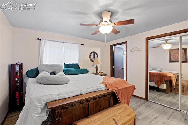 bedroom featuring a closet, light hardwood / wood-style flooring, and ceiling fan