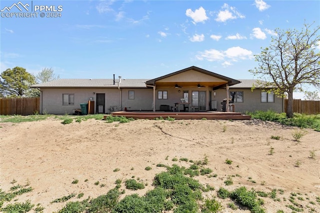 back of property featuring a deck and ceiling fan