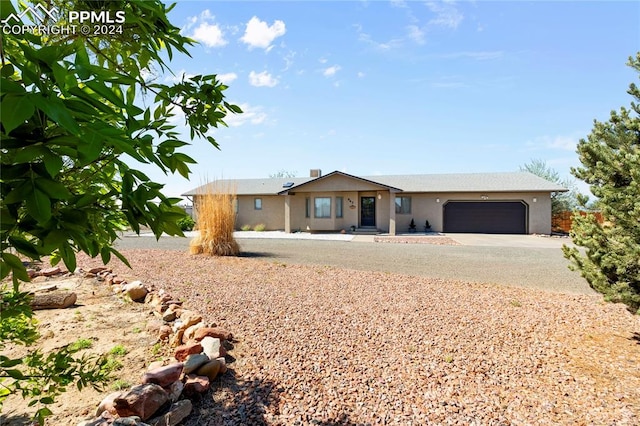 ranch-style home featuring a garage