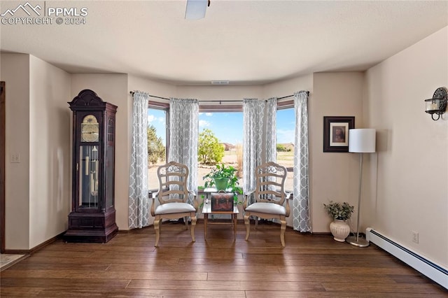 unfurnished room featuring a baseboard radiator and dark hardwood / wood-style flooring