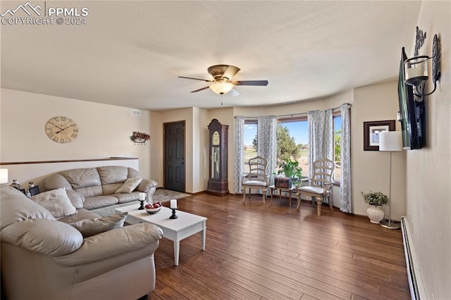 living room featuring ceiling fan, dark hardwood / wood-style floors, and a baseboard radiator