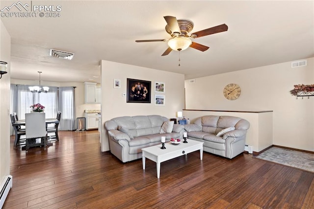 living room with dark hardwood / wood-style flooring, ceiling fan with notable chandelier, and baseboard heating