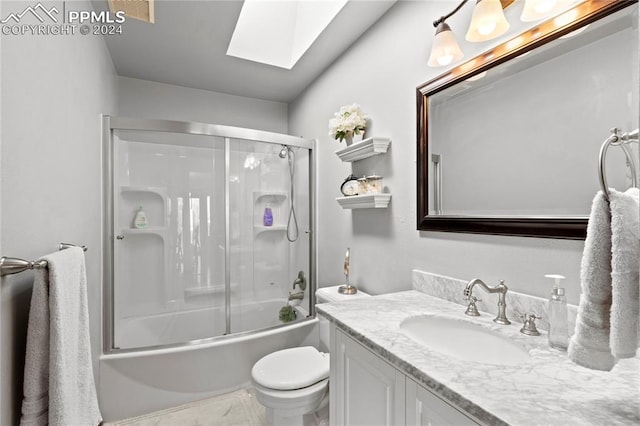 full bathroom featuring toilet, combined bath / shower with glass door, tile flooring, vanity, and a skylight