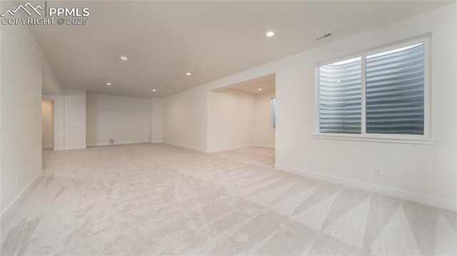 empty room with carpet, visible vents, baseboards, and recessed lighting