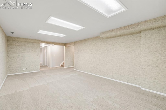 basement featuring light carpet