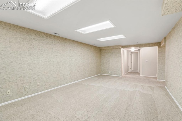 unfurnished room with light colored carpet