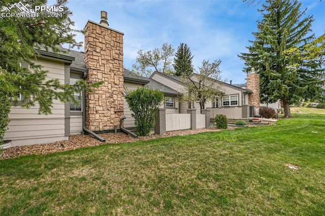 rear view of house with a yard