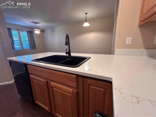 kitchen with ceiling fan, sink, dark wood-type flooring, black dishwasher, and pendant lighting