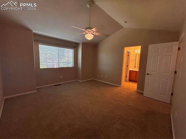 carpeted empty room featuring ceiling fan and vaulted ceiling