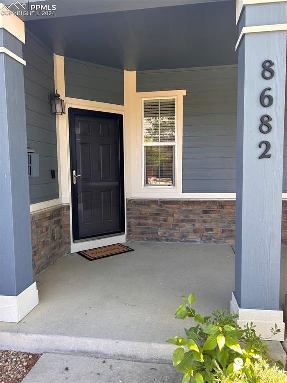 doorway to property featuring covered porch