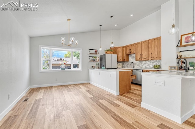 kitchen with a chandelier, dishwasher, kitchen peninsula, hanging light fixtures, and light hardwood / wood-style floors