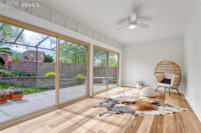 unfurnished sunroom featuring ceiling fan