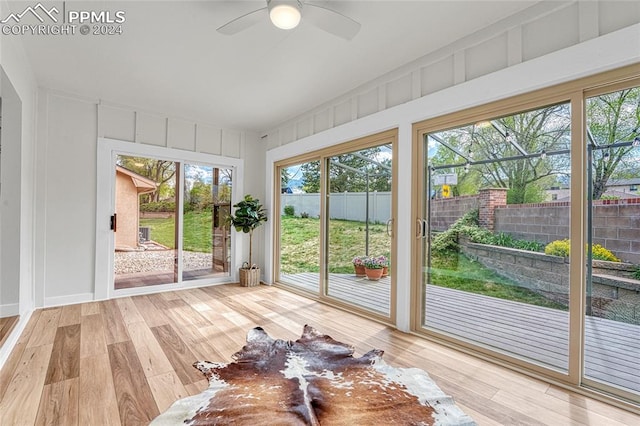 unfurnished sunroom featuring ceiling fan