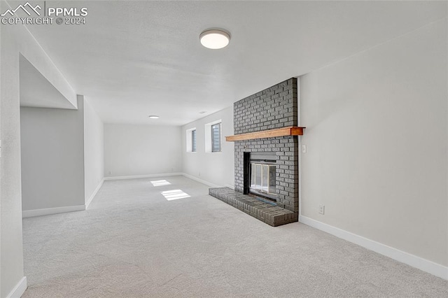 unfurnished living room featuring carpet and a fireplace