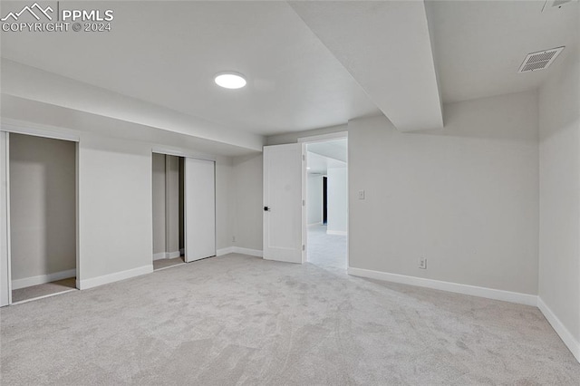 basement featuring light colored carpet