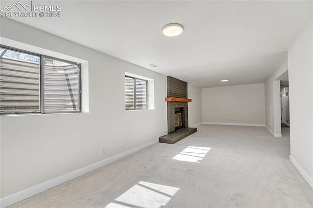 interior space featuring a fireplace and light carpet