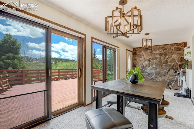 dining room featuring a notable chandelier and a textured ceiling