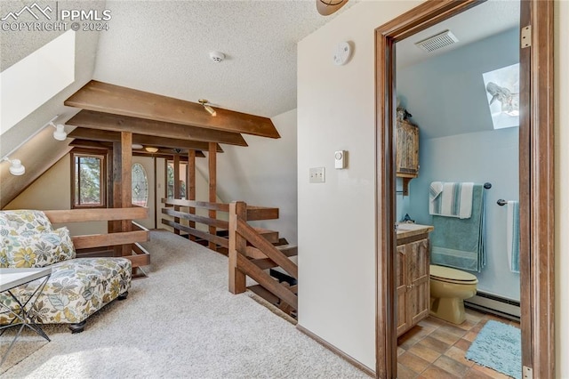 sitting room featuring carpet, a baseboard heating unit, a textured ceiling, and lofted ceiling