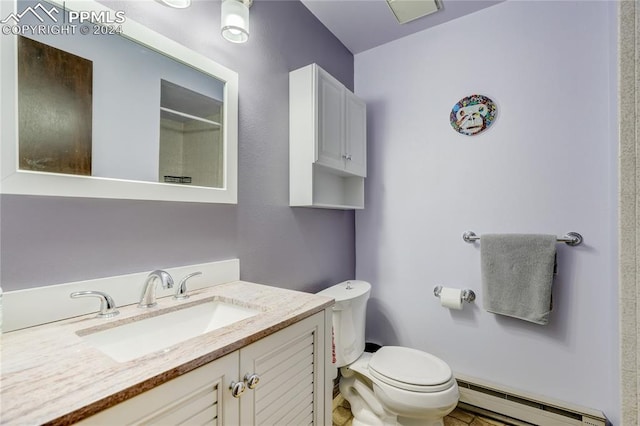 bathroom featuring baseboard heating, oversized vanity, toilet, and tile floors