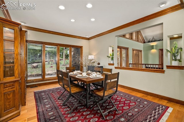 dining space featuring light hardwood / wood-style flooring and ornamental molding