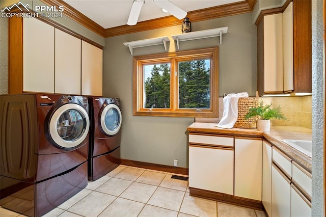 washroom with cabinets, ceiling fan, independent washer and dryer, ornamental molding, and light tile patterned floors