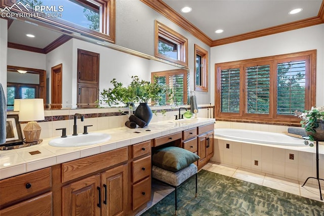 bathroom with vanity, a healthy amount of sunlight, and a relaxing tiled tub