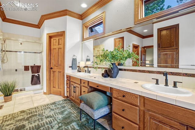 bathroom with tile patterned flooring, vanity, walk in shower, and crown molding