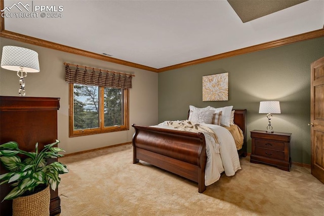 bedroom with crown molding and light carpet