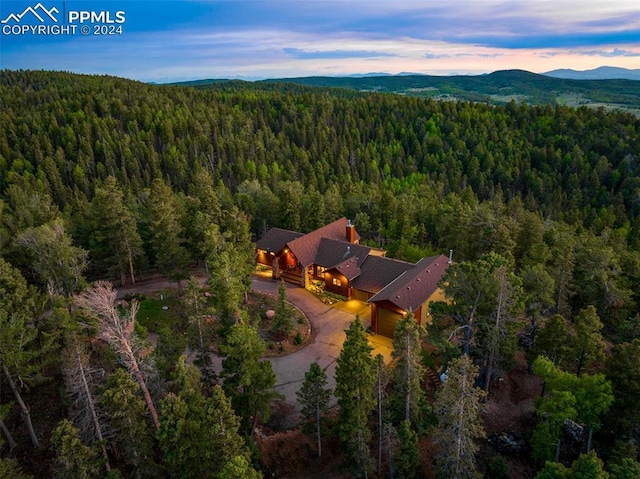 aerial view at dusk featuring a mountain view