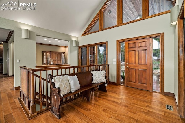 entrance foyer with light hardwood / wood-style floors and high vaulted ceiling