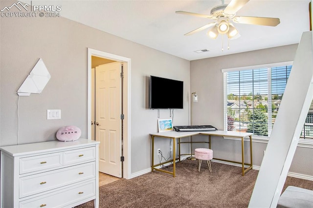 home office featuring ceiling fan and light carpet