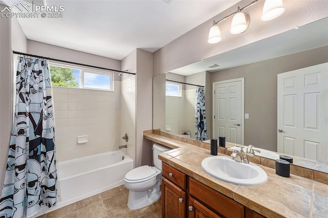 full bathroom featuring tile patterned floors, toilet, shower / bathtub combination with curtain, and vanity