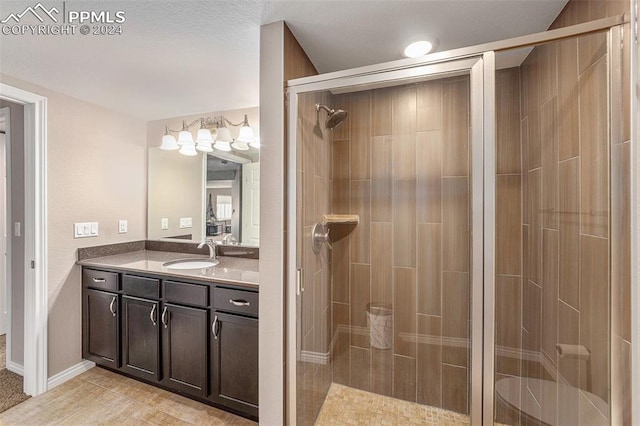 bathroom with tile patterned flooring, an enclosed shower, and vanity