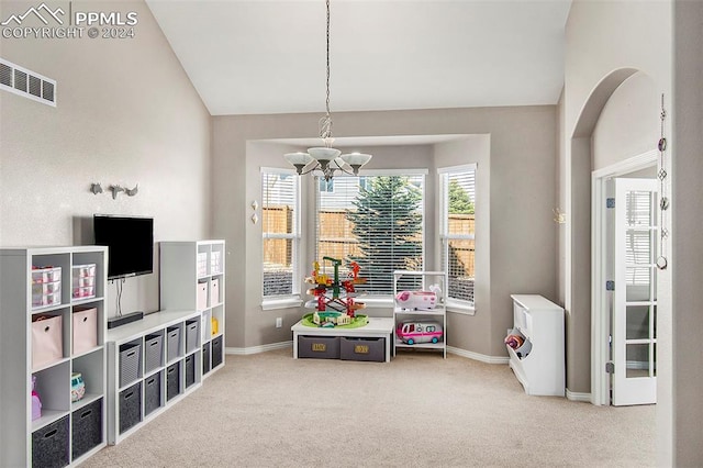 rec room featuring carpet, a notable chandelier, and lofted ceiling