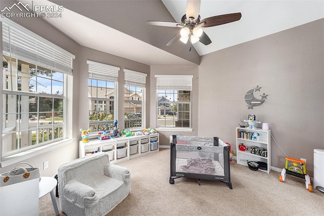 rec room with ceiling fan, vaulted ceiling, and carpet